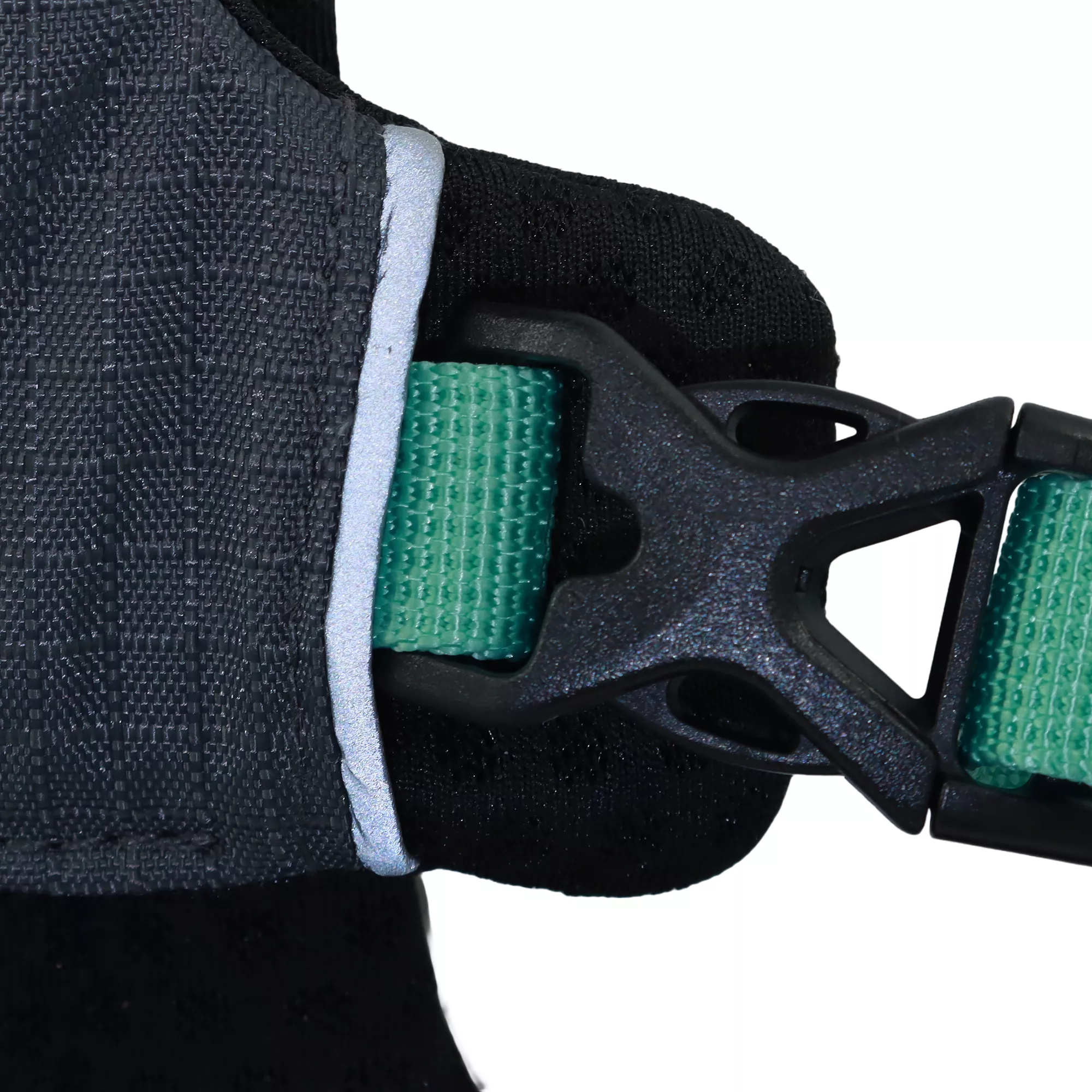A Boulder‑colored dog harness is displayed against a white background. The front chest panel is charcoal gray with reinforced stitching. A plastic x-buckle is attached via a green strap stitched into the harness.