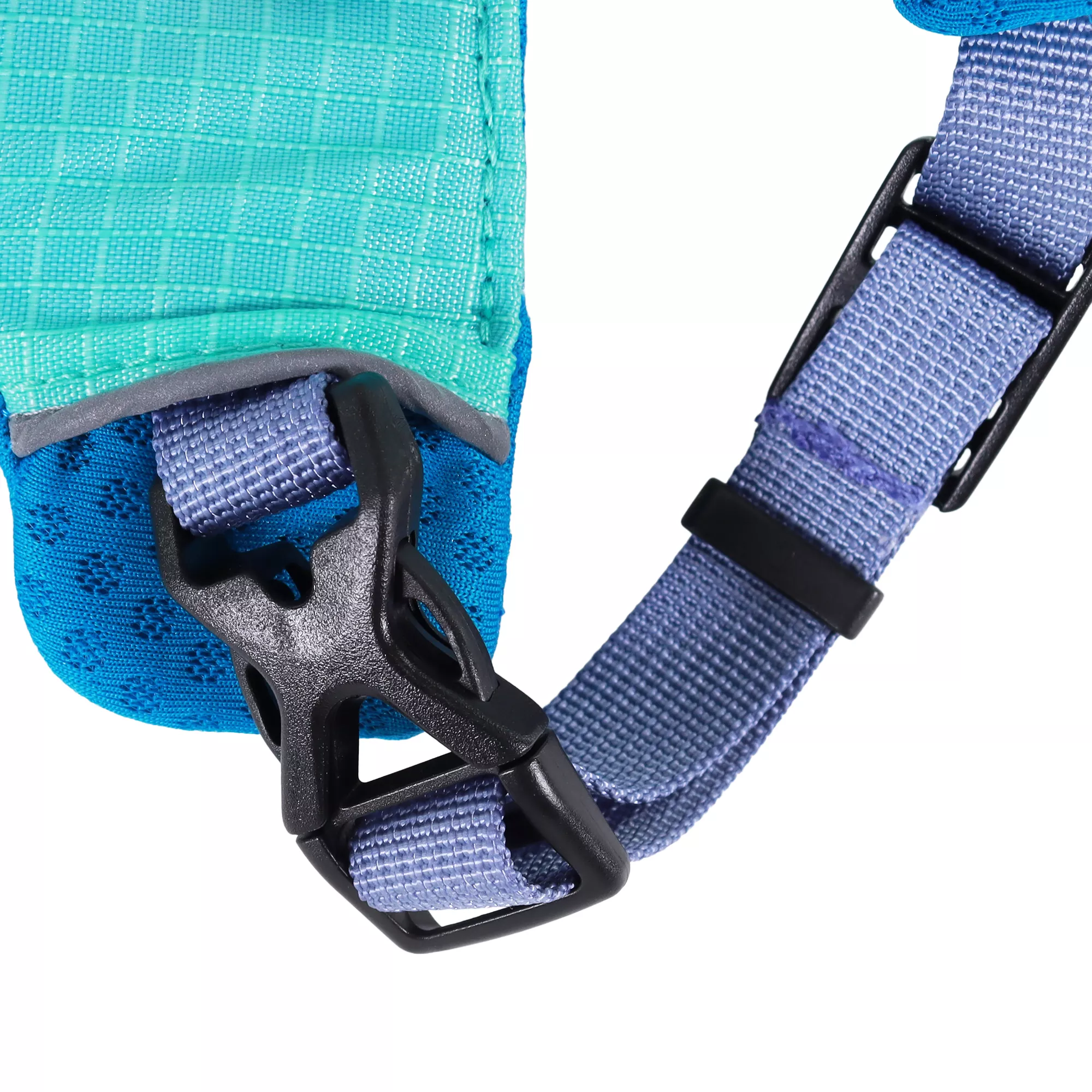 An atlantic‑colored dog harness is displayed against a white background. The front chest panel is bright teal with reinforced stitching. A plastic x-buckle is attached via a light blue strap stitched into the harness.