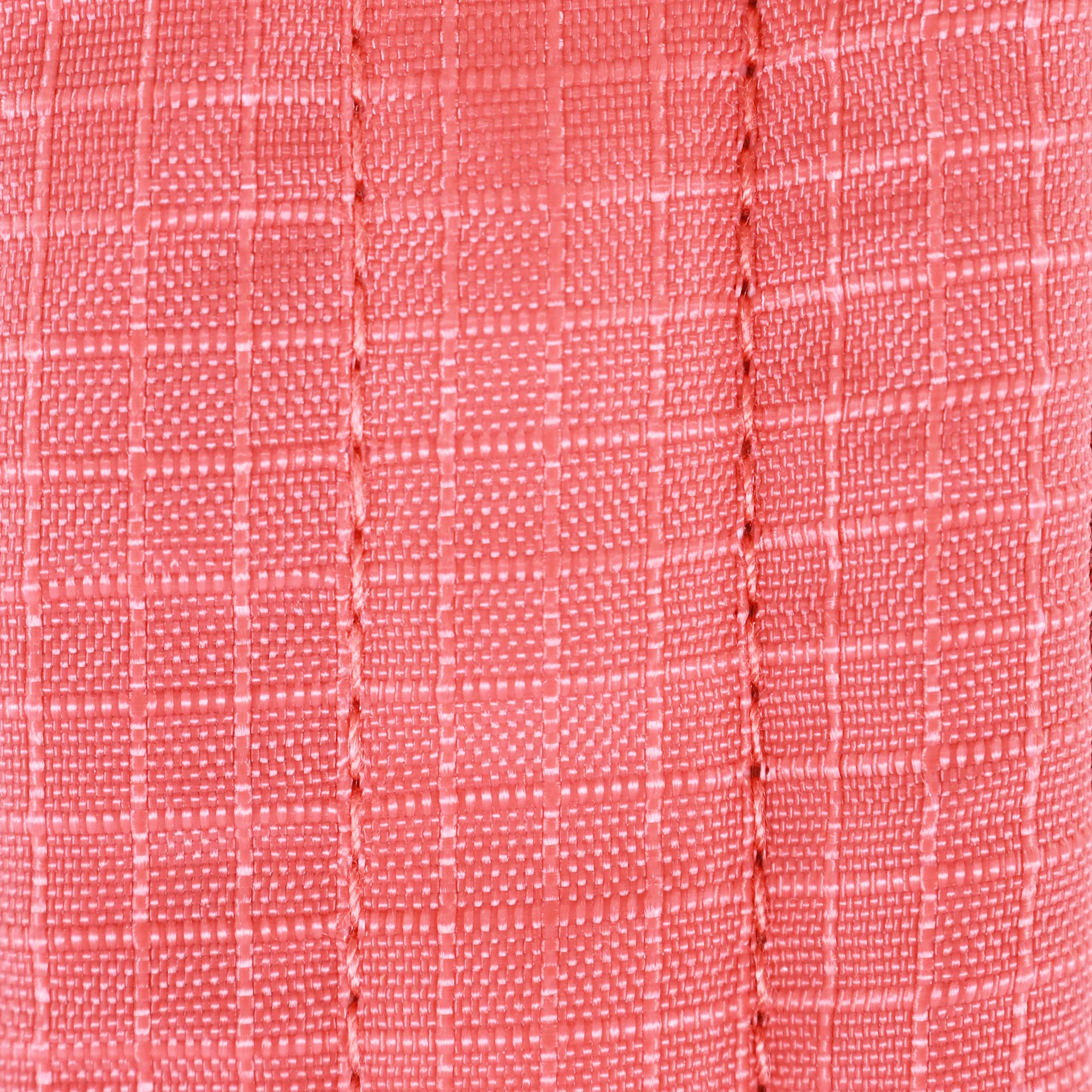 A closeup of the external material of a full-coverage harness. The material is bright red and has a grid pattern.